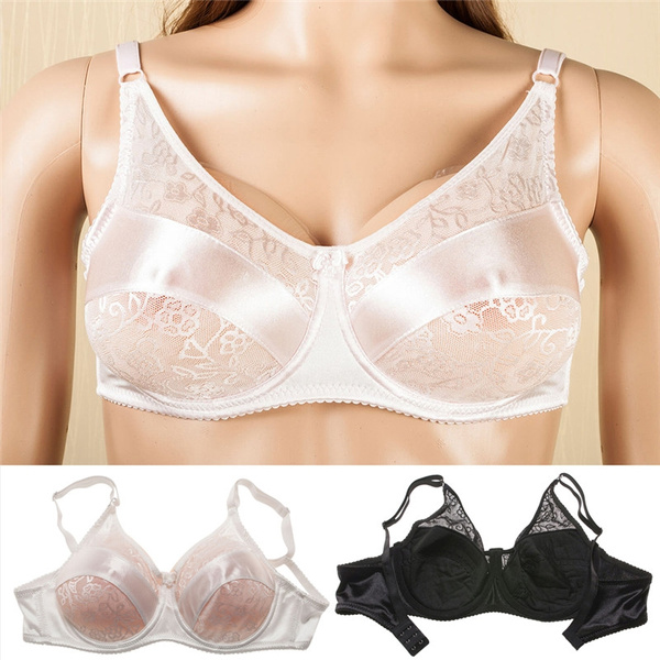 Women's Breasts In Black Bra With White Flowers. Female Breast