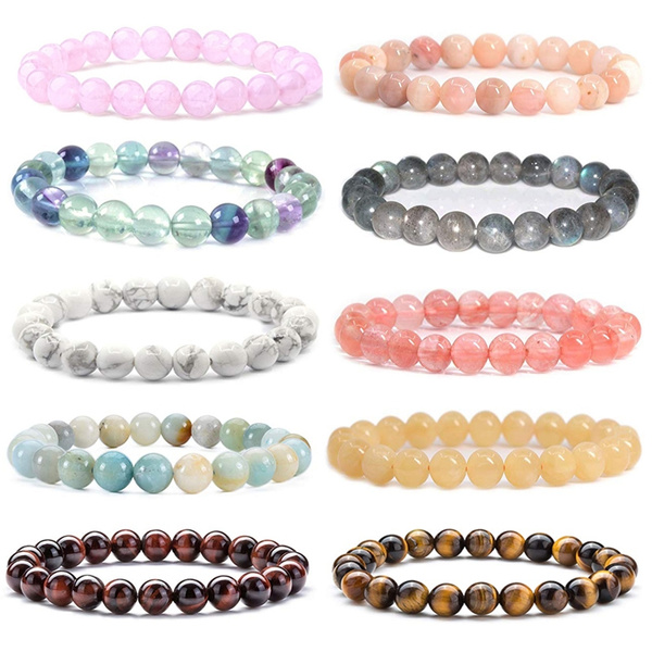 Gemstone necklaces and bracelets in a row. Luxury jewelry made of blue lace  agate crystal, mountain quartz and red coral stone. Healing, powerful  crystal energy, esoteric and colorful background Stock Photo |