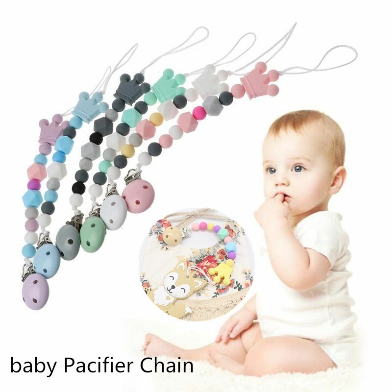 baby chewing on pacifier teething