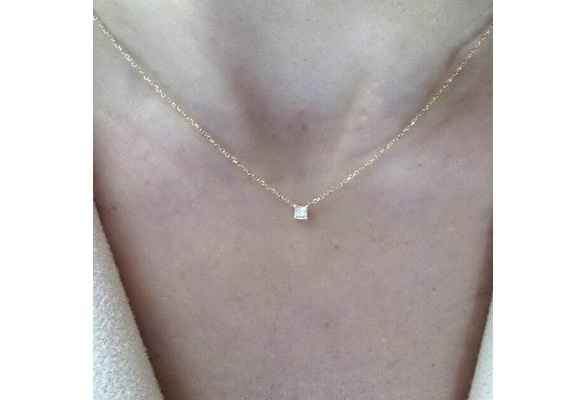 dainty gold necklace with small diamond