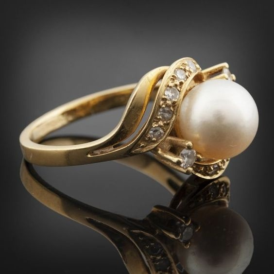 Sold at Auction: Platinum pearl-diamond-ring